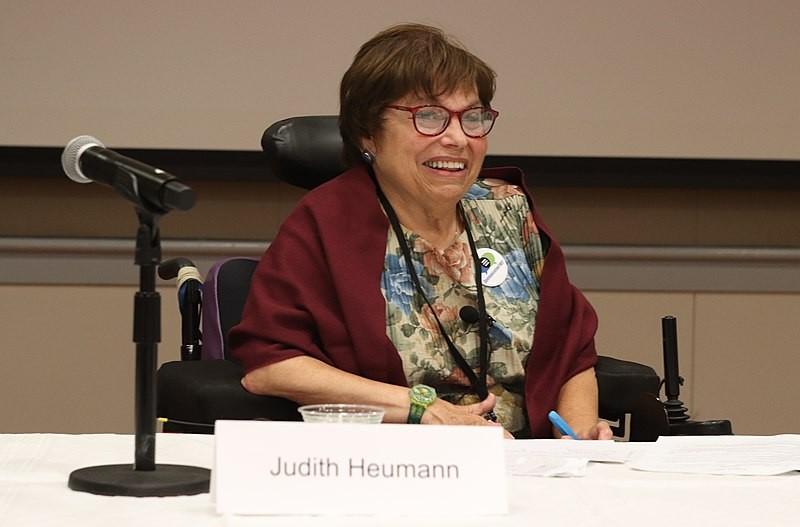 Judith Heumann, Mother of Disability Rights, sitting at a conference table. 