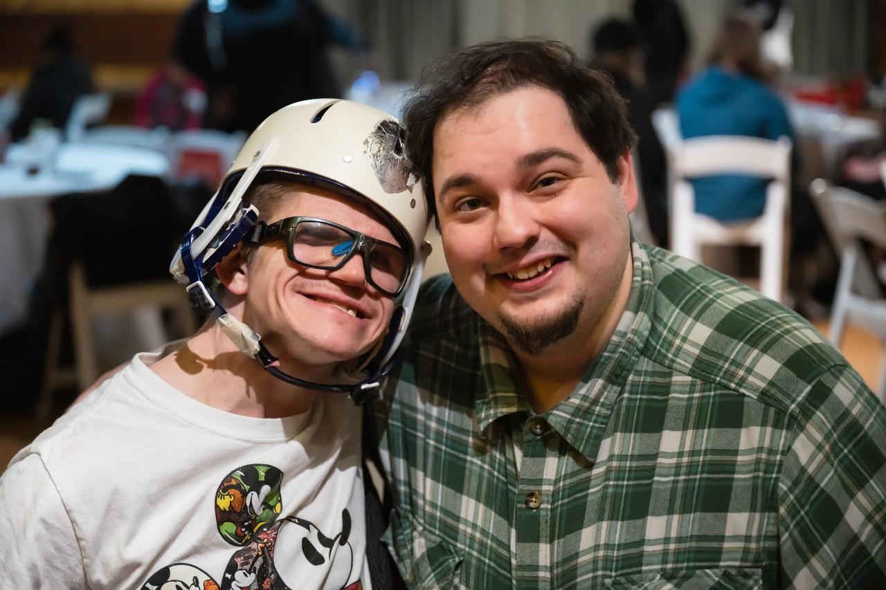 An ALSO direct support professional poses with an intellectually disabled client at the ALSO holiday party.