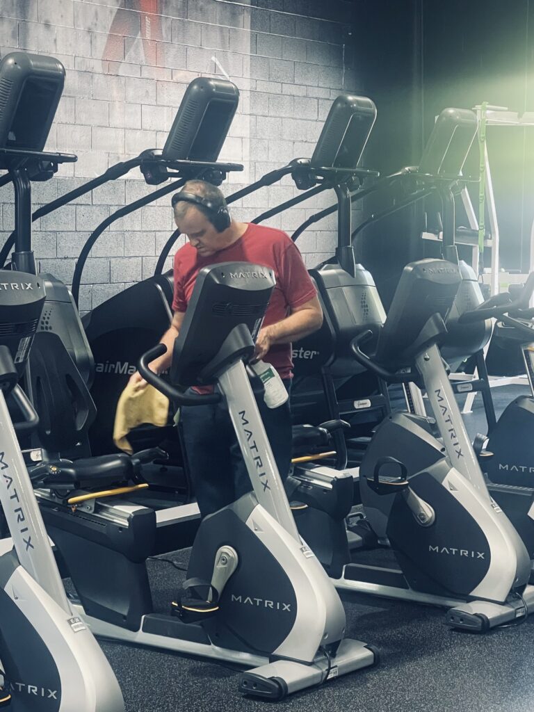 Andrew works in a fitness gym, cleaning equipment, as part of ALSO's supported employment services.