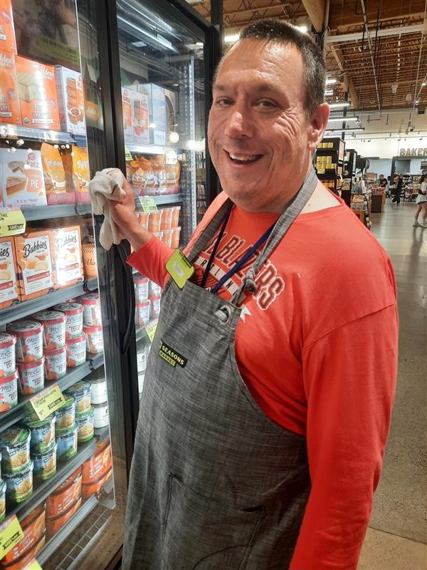 Gerry works stocking products in a grocery store as part of ALSO's supported employment services.