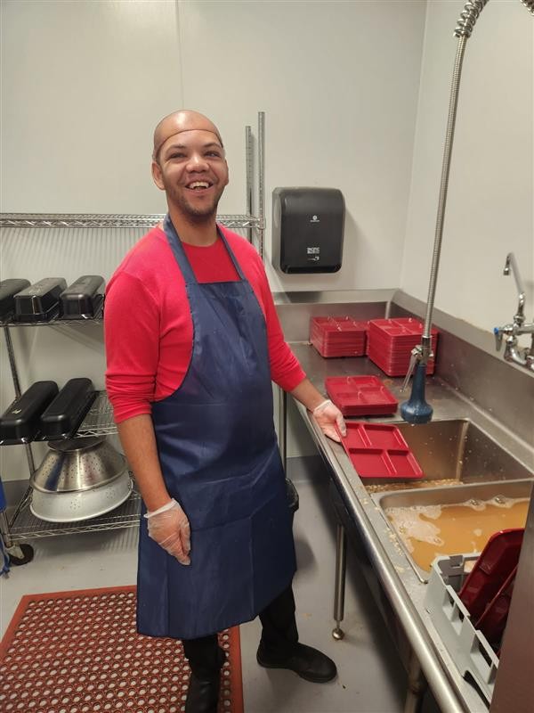Skylar works in the kitchen of an elementary school as part of ALSO's supported employment services.