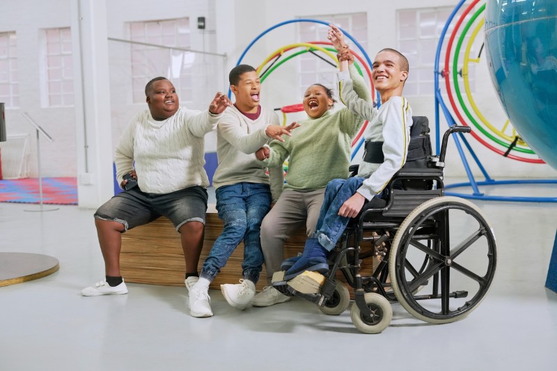 A group of developmentally disabled friends laughing together. 